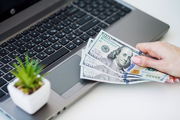 Borrower checking refinance readiness alerts on a laptop